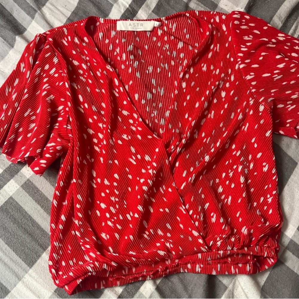 ASTR the label red crop top with white polka dots.
